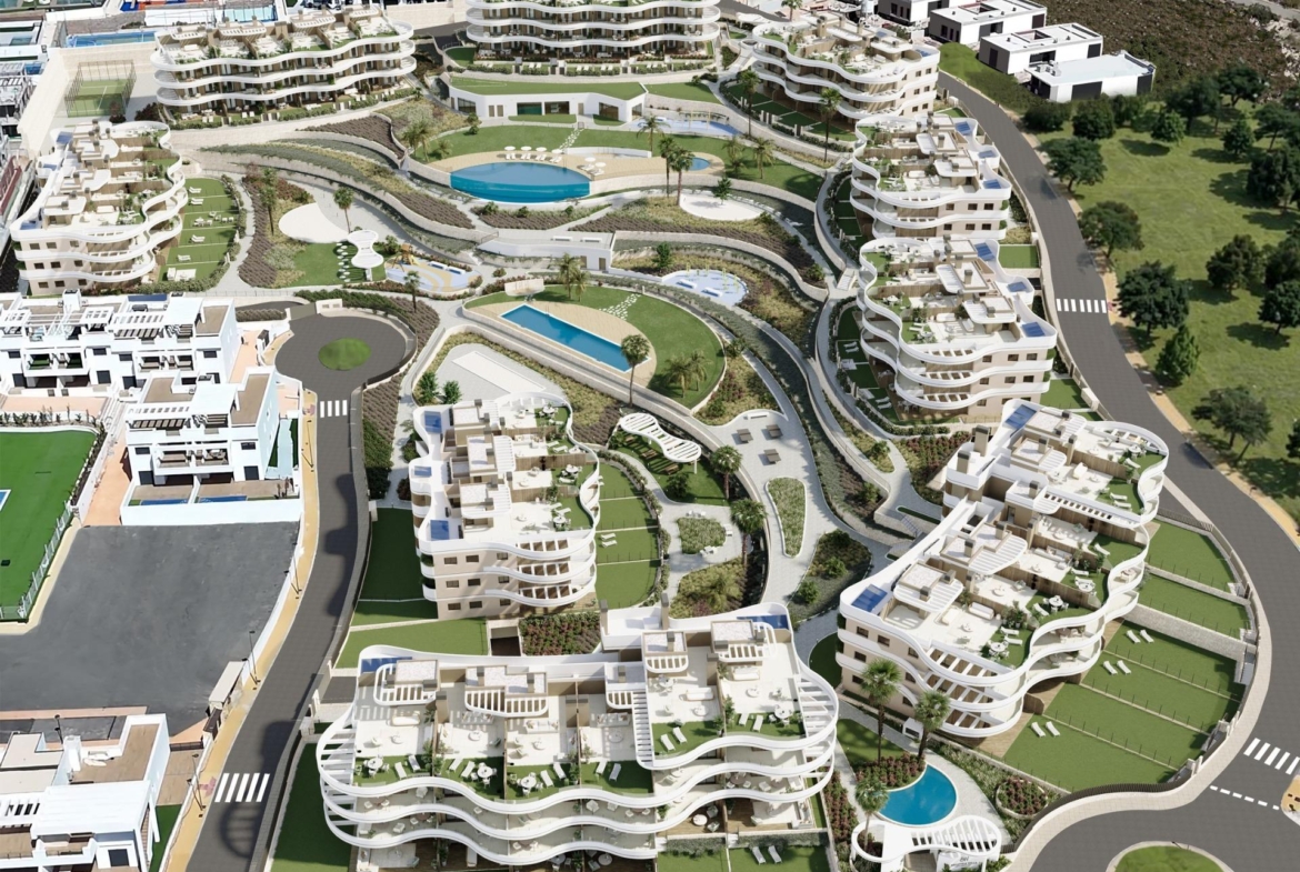 Modern new build apartments in Finestrat featuring curving terraces, lush landscaped gardens, multiple pools, and panoramic sea views.