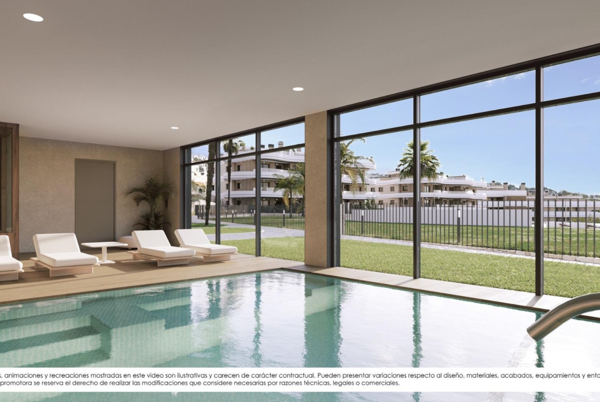 Bright indoor pool with sleek loungers and large windows overlooking landscaped grounds at new build apartments in Finestrat.