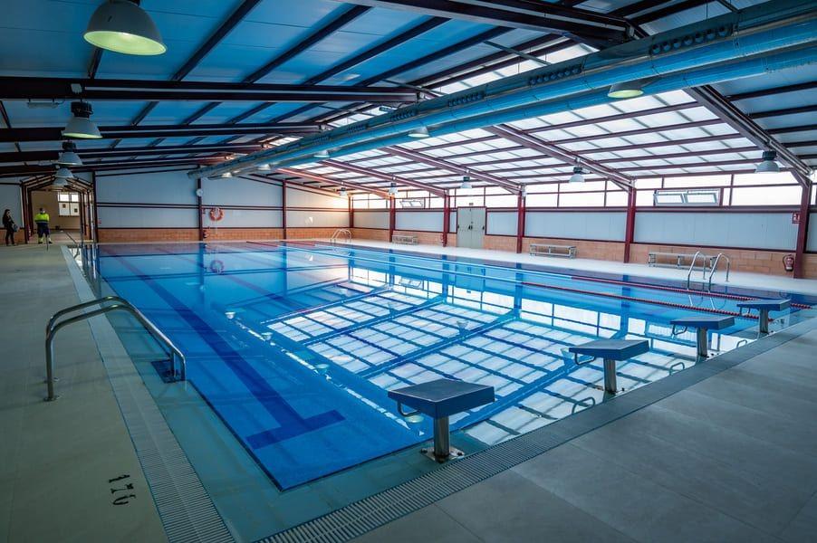 Bright, spacious indoor communal pool with sleek design, part of a modern 2-bedroom apartment complex in Bigastro, Costa Blanca.