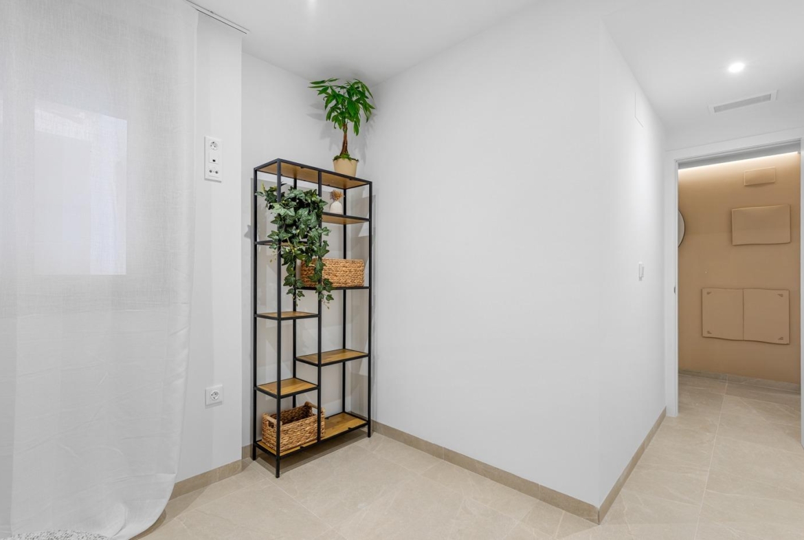 Bright modern hallway with minimalist shelving in a new build 3 bedroom ground floor apartment in Jacarilla