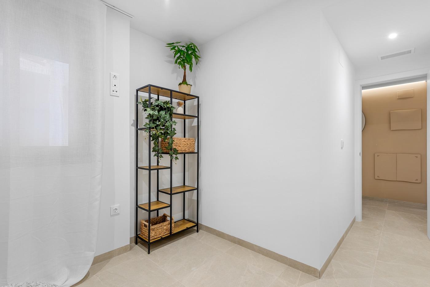Bright modern hallway with minimalist shelving in a new build 3 bedroom ground floor apartment in Jacarilla