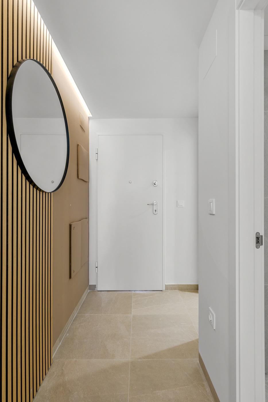 Bright modern hallway with elegant wood paneling in luxury 3 bedroom apartment with open views in Jacarilla