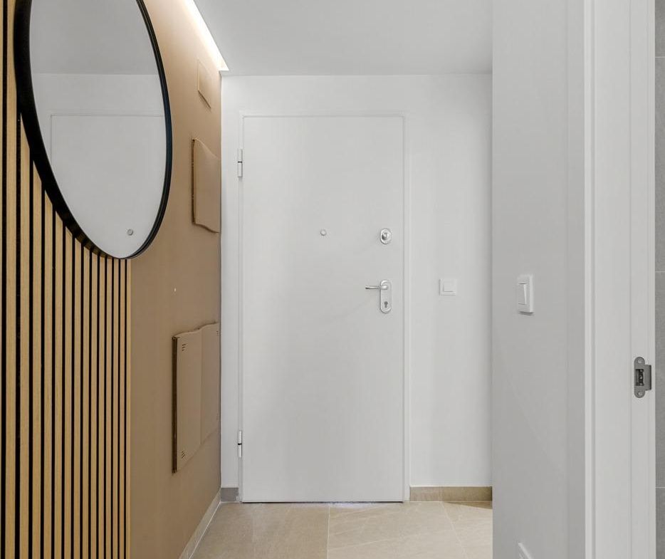 Bright modern entrance hallway with stylish wood paneling in affordable 3-bedroom ground floor apartment in Jacarilla