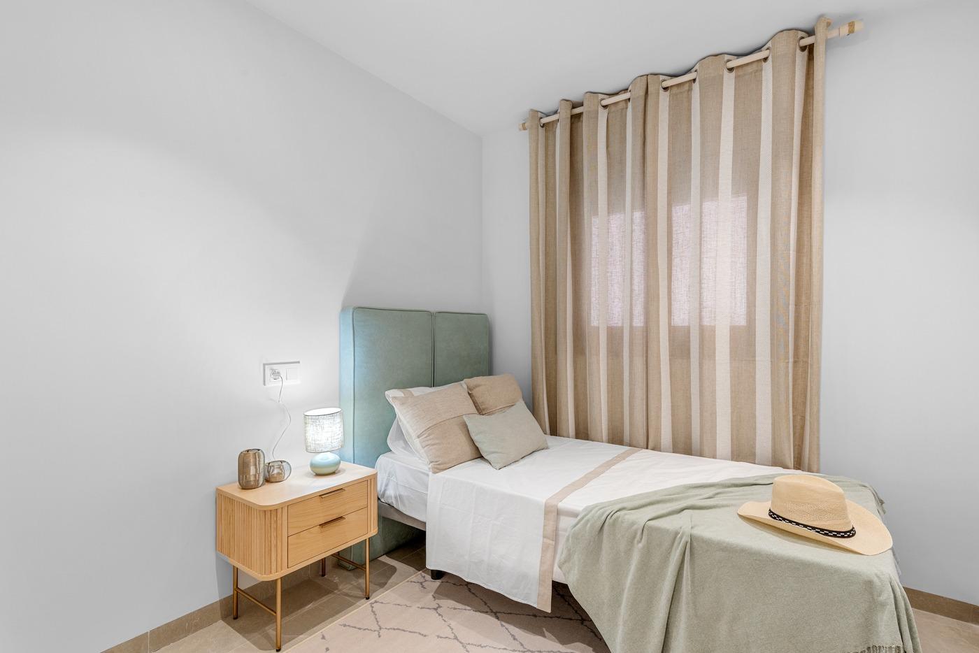 Bright and modern bedroom in a new build 3-bedroom apartment in Jacarilla featuring soft natural tones and minimalist design.