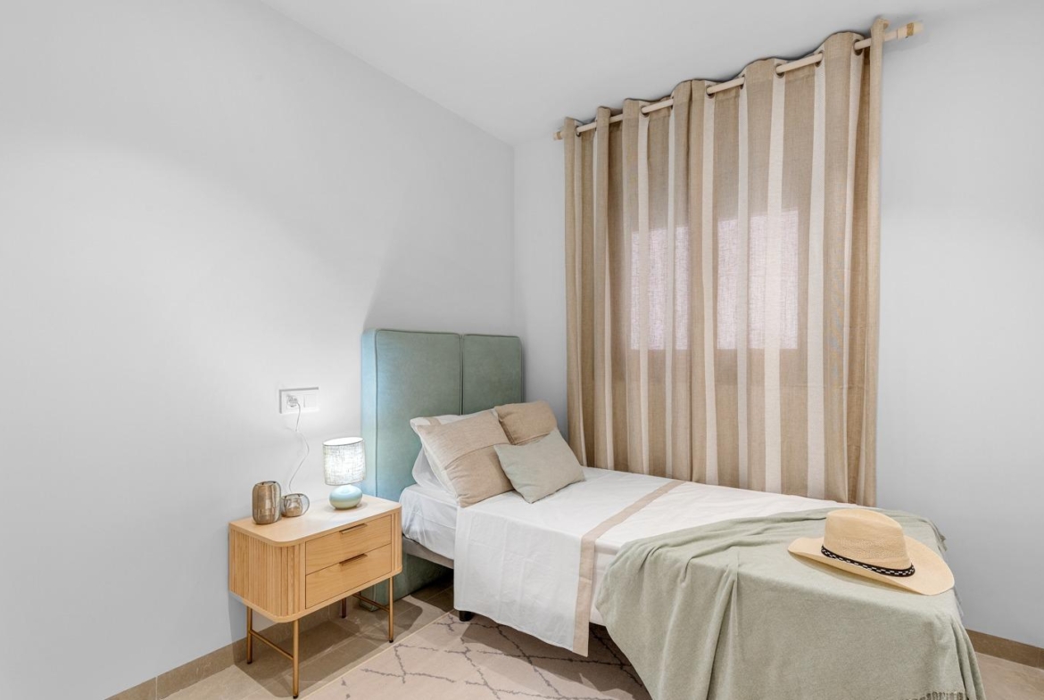 Bright and airy 3-bedroom ground floor apartment bedroom with soft muted tones and modern decor in Jacarilla new build.