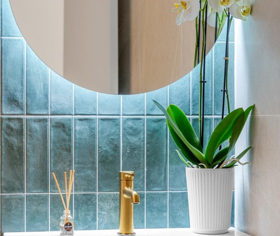 Elegant bathroom sink with gold faucet and decorative orchid in new build 3 bedroom penthouse in Jacarilla