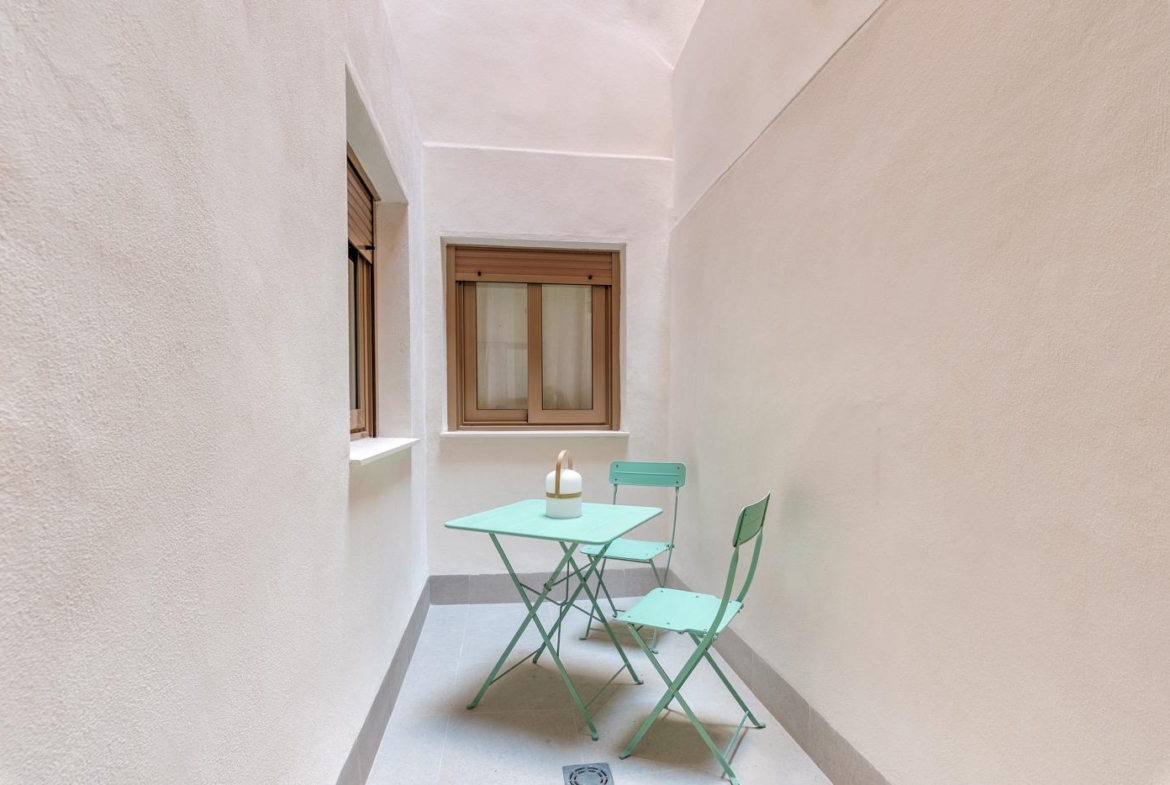 Cozy private courtyard with minimalist pastel furniture in a modern new build 3-bedroom apartment in Jacarilla.