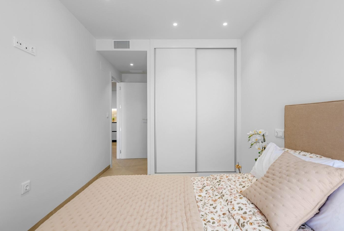 Bright modern bedroom with elegant neutral tones in a 3 bedroom new build apartment for sale in Jacarilla