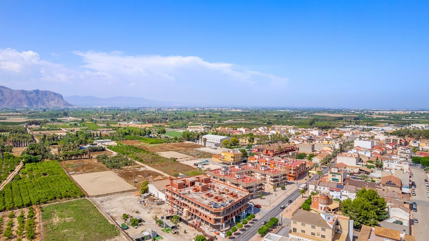 Expansive aerial view of modern new build apartments with open panoramic countryside views in Jacarilla.