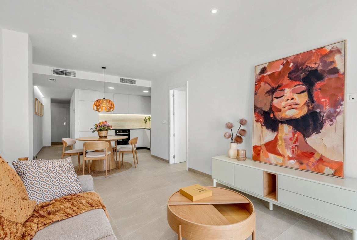 Bright modern living and dining area with tasteful artwork in a 3-bedroom apartment with open views in Jacarilla.