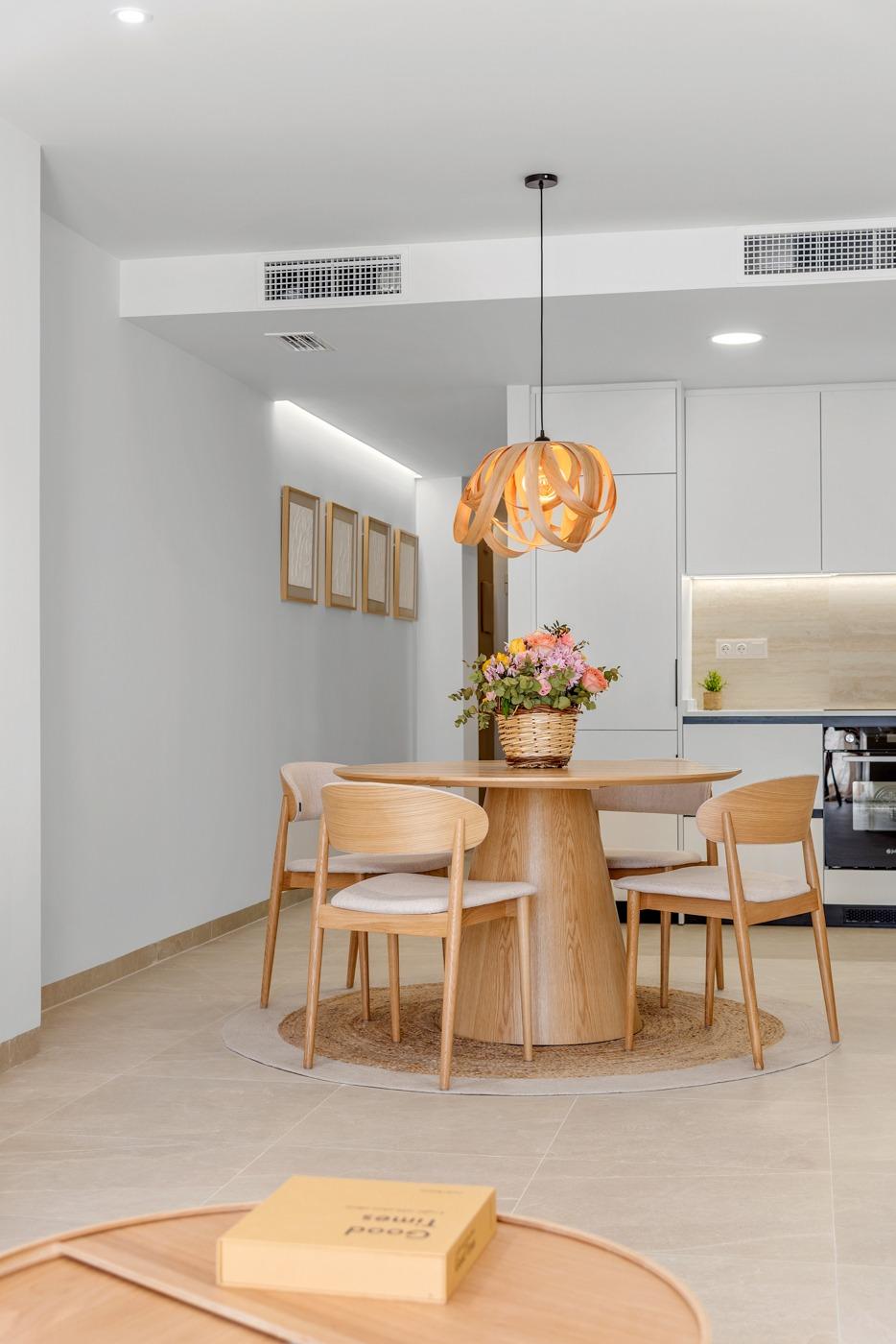 Bright modern dining area with elegant wooden furniture in a new build 3 bedroom penthouse in Jacarilla.