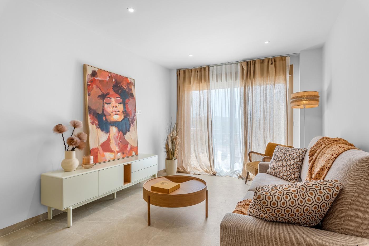 Bright, modern living room with elegant decor and sheer curtains in a new build 3 bedroom penthouse with terrace in Jacarilla.