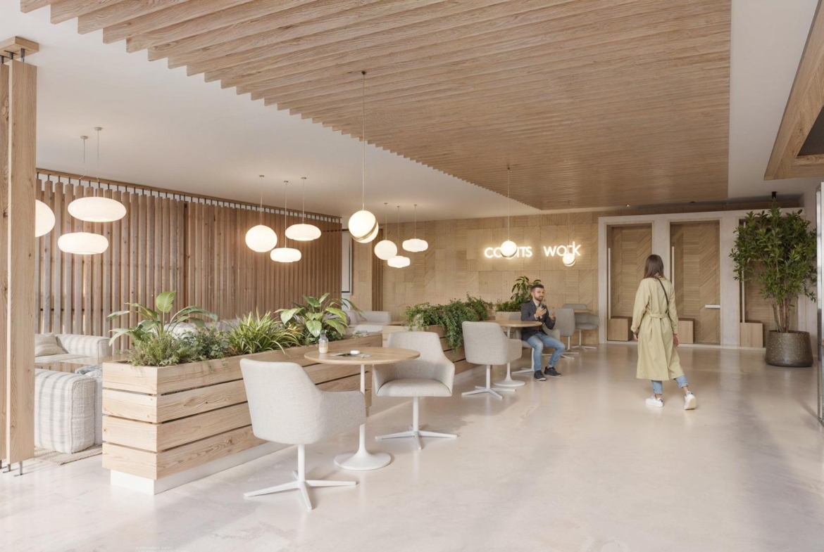 Bright, modern communal lounge with elegant wooden accents in a contemporary 3-bedroom apartment building in La Nucía, Alicante.