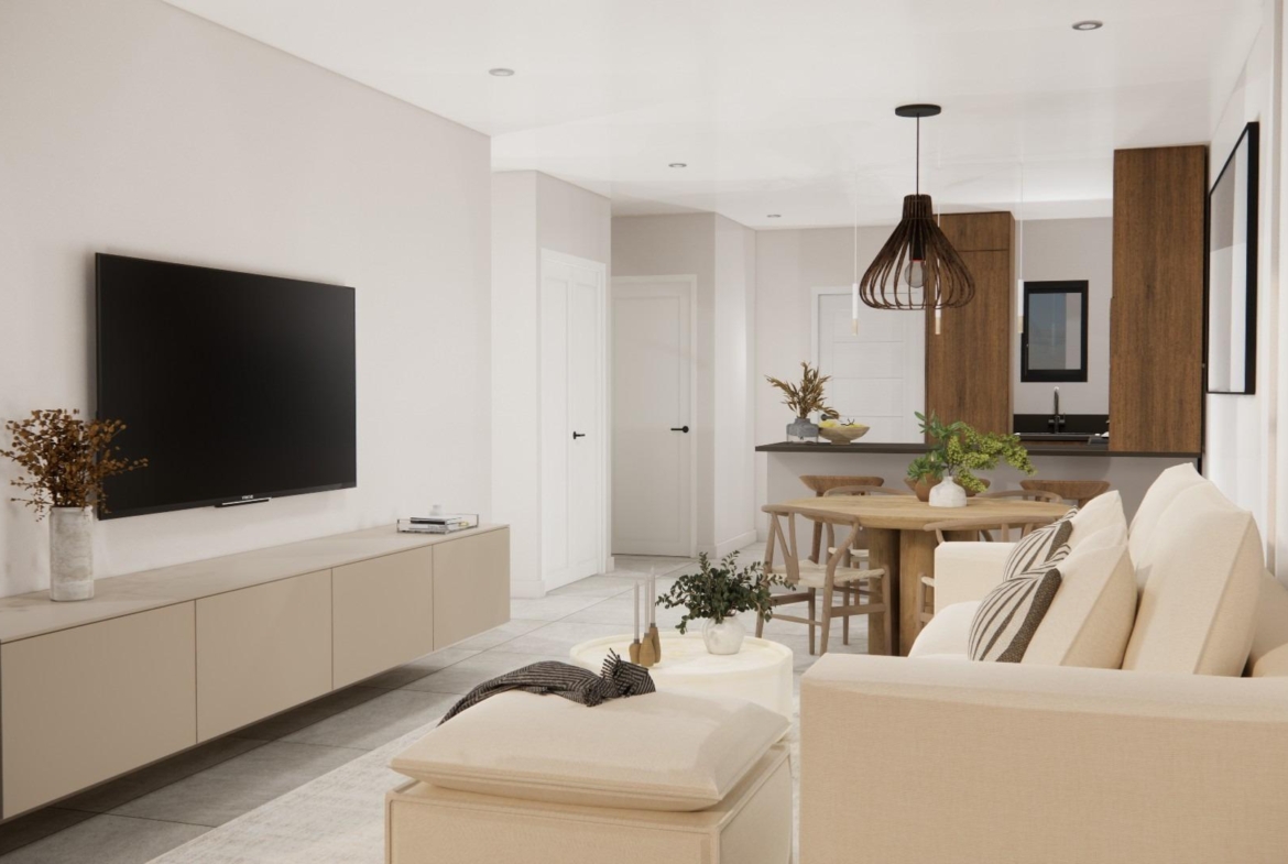 Bright modern living room with elegant sofa and open-plan kitchen in a 2-bedroom ground floor apartment in Rojales, Costa Blanca South.