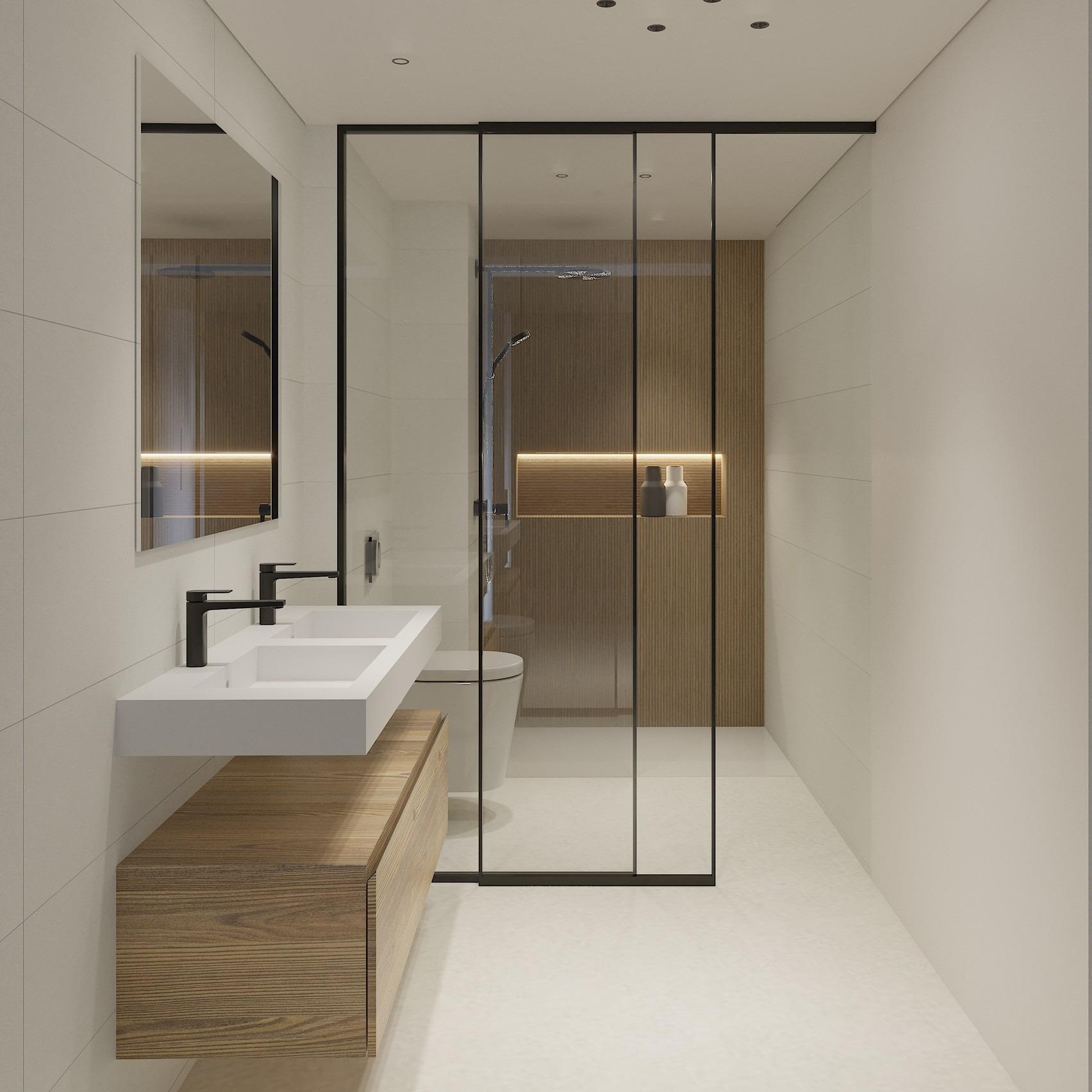 Modern, spacious bathroom with sleek double sink, glass shower enclosure, and warm wood accents in luxury La Mata top floor apartment.