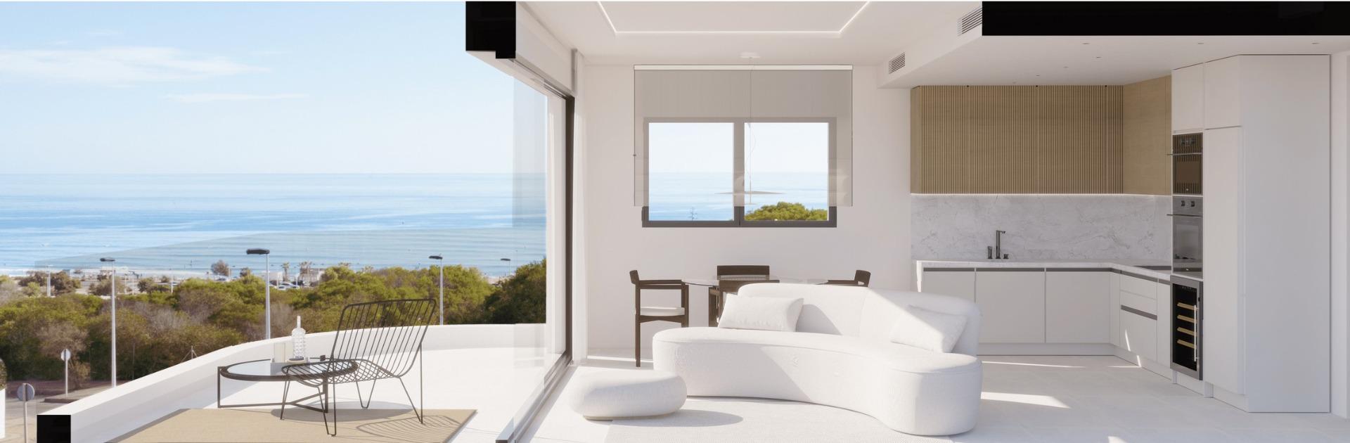 Bright open-plan living area with modern kitchen and panoramic sea views in luxury ground floor apartment, La Mata, Torrevieja