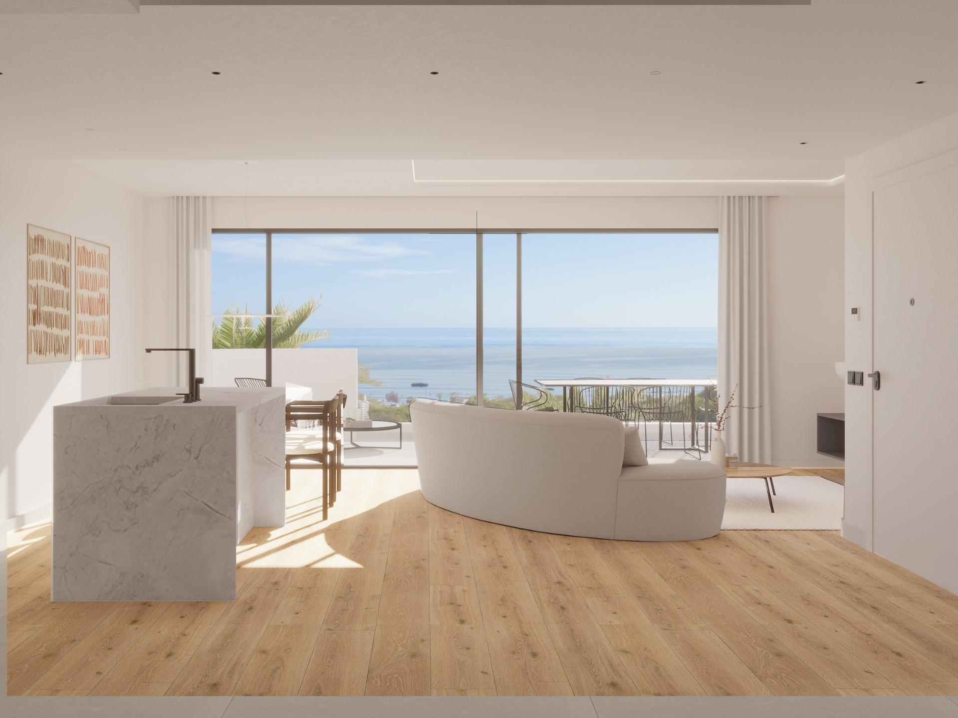 Bright modern top floor apartment living area with marble kitchen island and panoramic sea views in La Mata, Torrevieja.