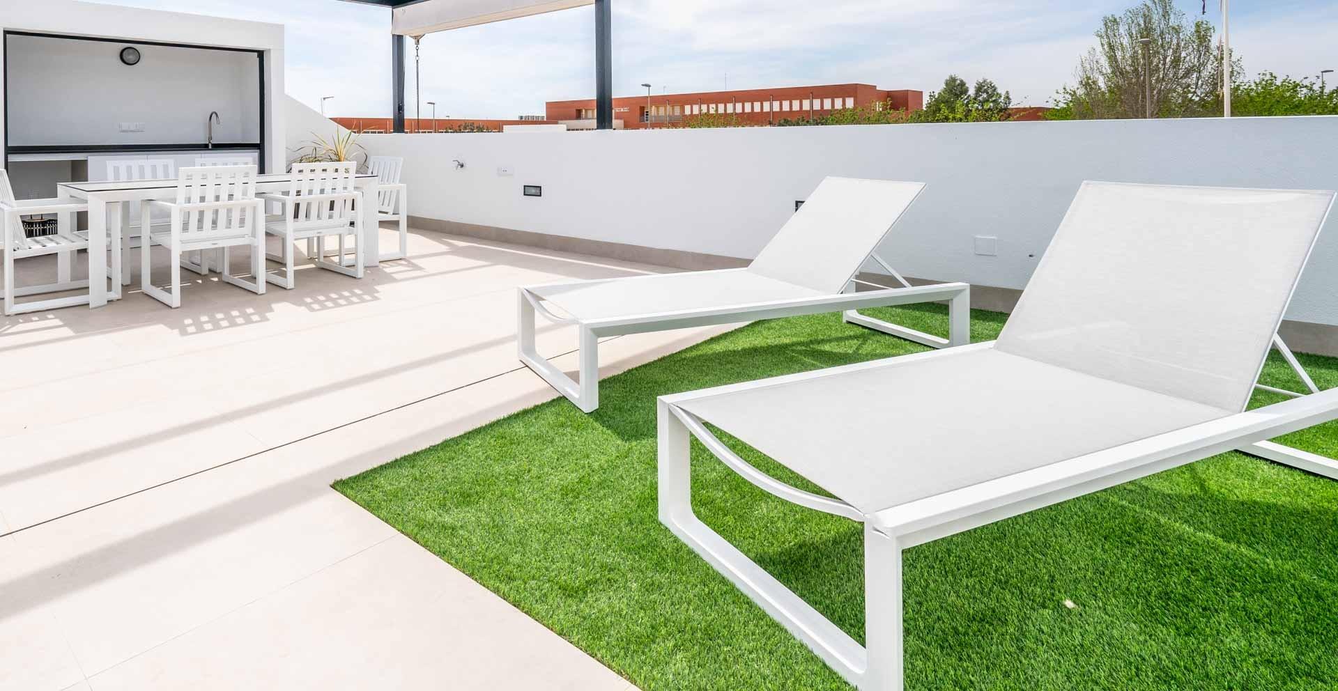 Sun-drenched terrace with sleek white loungers and outdoor dining area at Mediterranean single-storey villa in Roldán, Torre-Pacheco