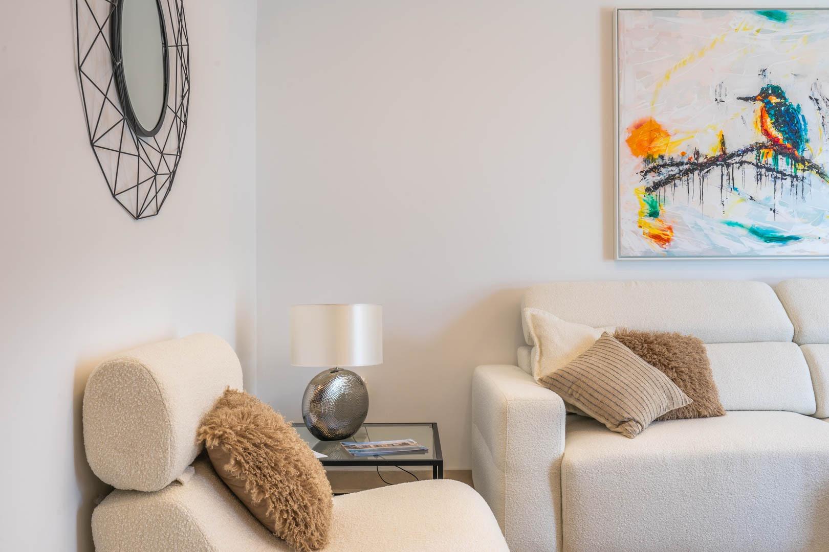 Cozy, modern sitting area with textured armchair and stylish white sofa in Mediterranean new build villa in Roldán, Torre-Pacheco.