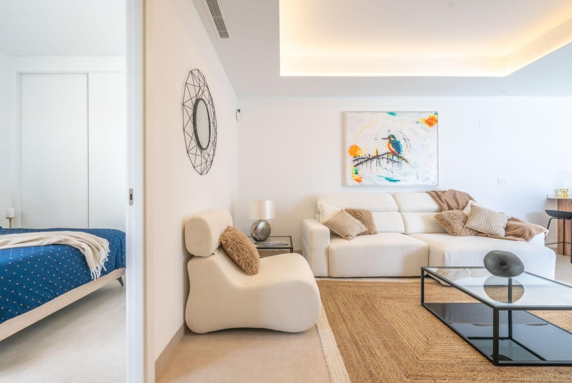 Bright and elegant open-plan living room with modern furnishings and bedroom in a Mediterranean single-storey villa, Roldán.
