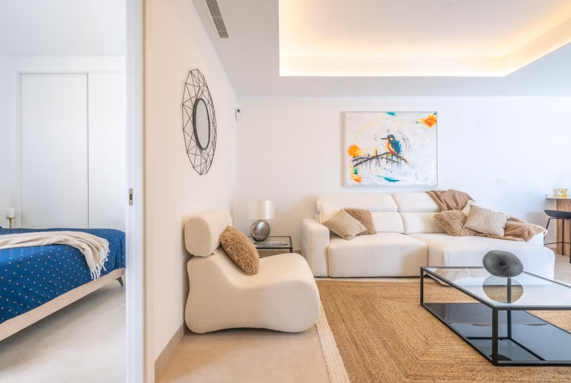 Bright and elegant open-plan living room with modern furnishings and bedroom in a Mediterranean single-storey villa, Roldán.