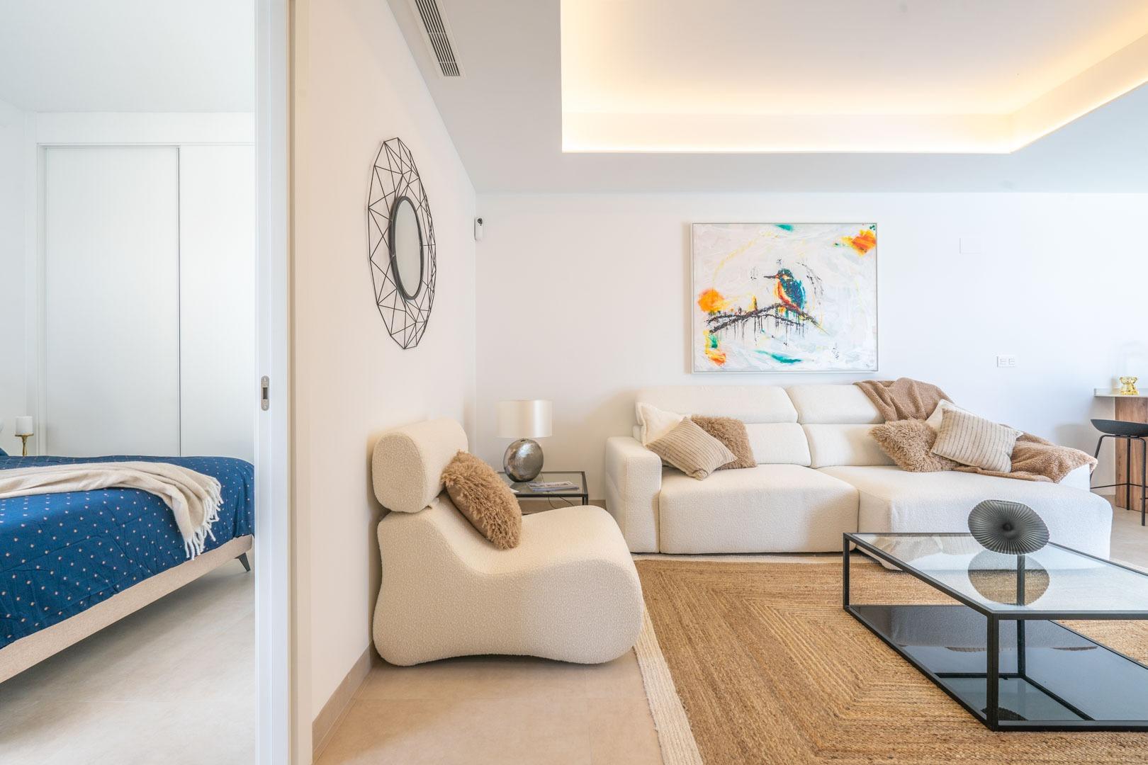 Bright and elegant open-plan living room with modern furnishings and bedroom in a Mediterranean single-storey villa, Roldán.