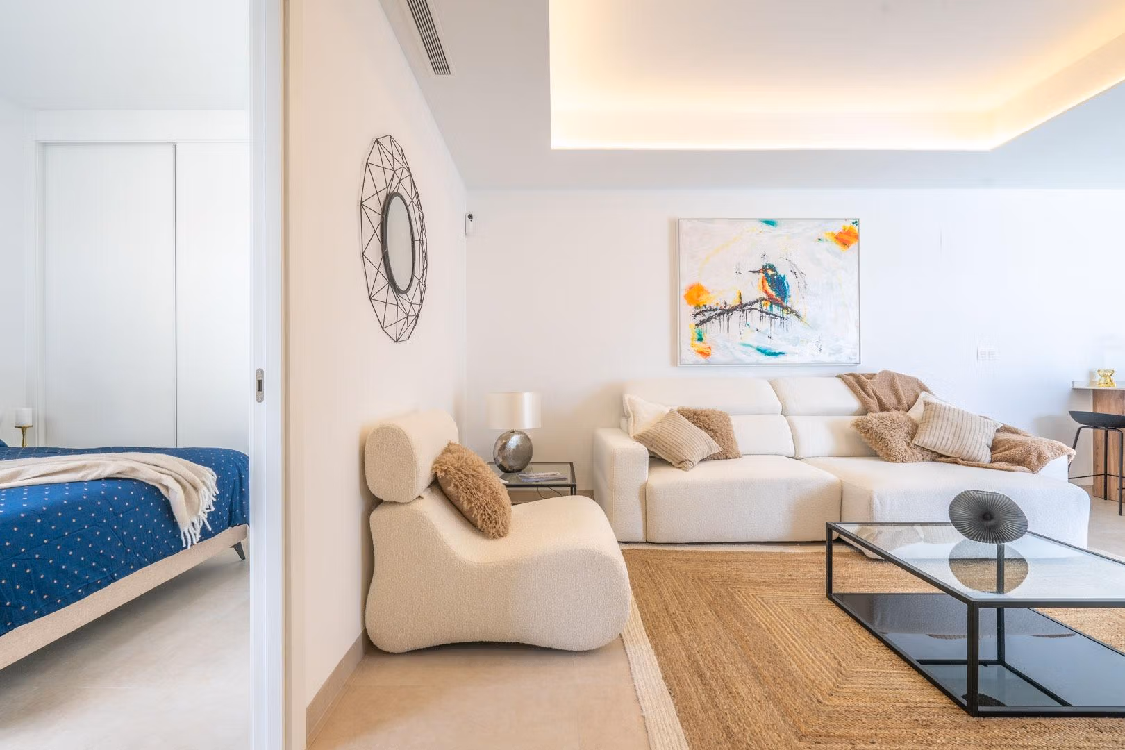 Bright and elegant open-plan living room with modern furnishings and bedroom in a Mediterranean single-storey villa, Roldán.