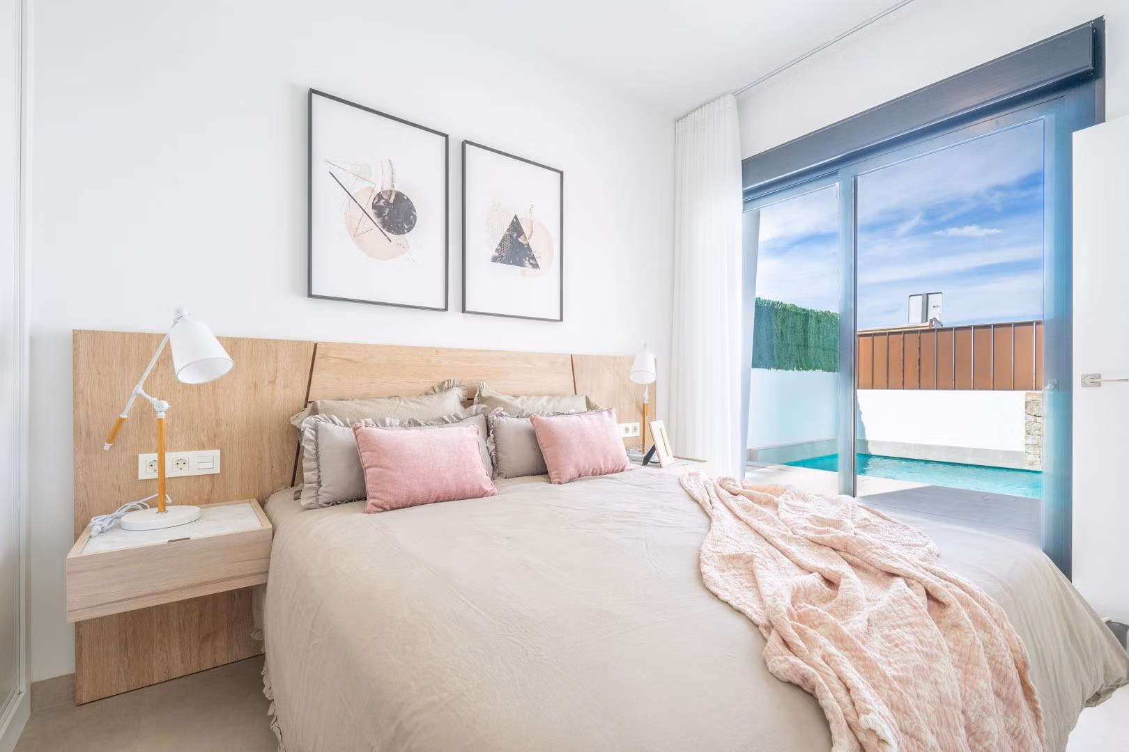 Bright, elegant bedroom with soft tones and private pool visible through glass door in Mediterranean single-storey villa, Roldán, Torre-Pacheco.
