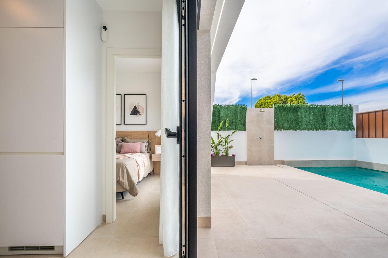 Bright modern bedroom and sleek private pool area at a Mediterranean new build single-storey villa in Roldán, Torre-Pacheco.