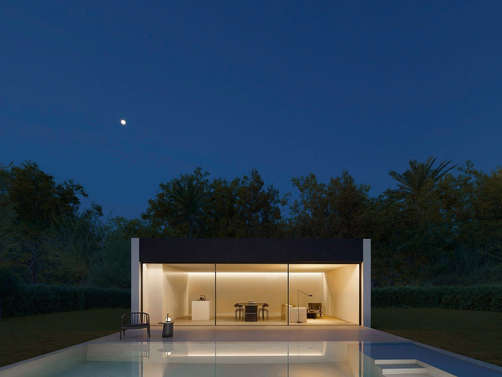 Elegant minimalist single-storey villa in Benidorm with glass-fronted open-plan interior and serene outdoor terrace under twilight sky.