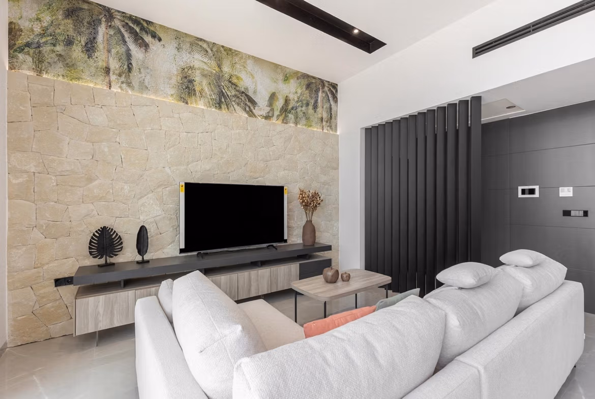 Bright and elegant living room with modern stone wall and sleek decor in key-ready single-storey villa, Los Balcones, Torrevieja.