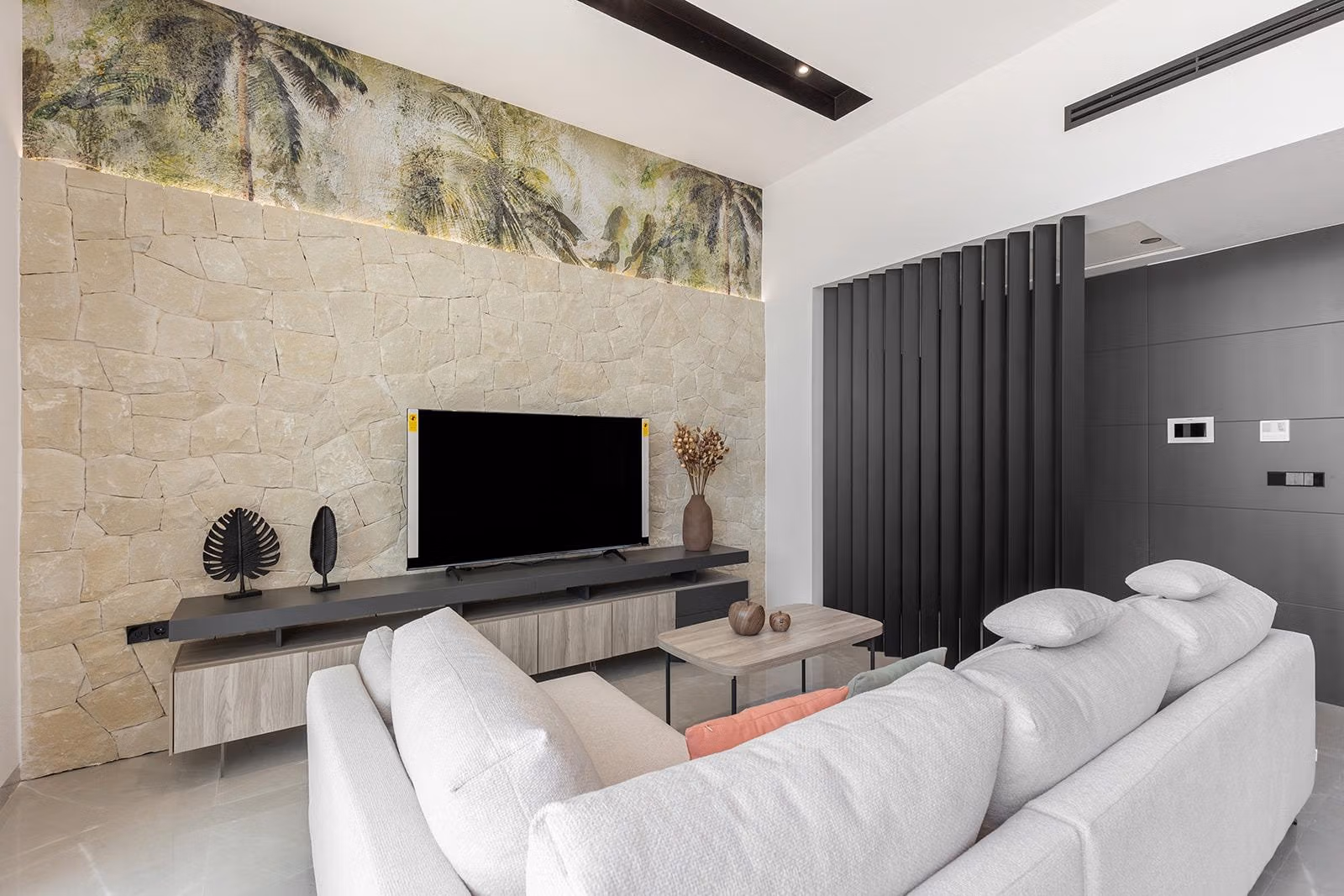 New-Build-One-Story-Villas-with-Private-Pool-in-Torrevieja-19 Bright and elegant living room with modern stone wall and sleek decor in key-ready single-storey villa, Los Balcones, Torrevieja.