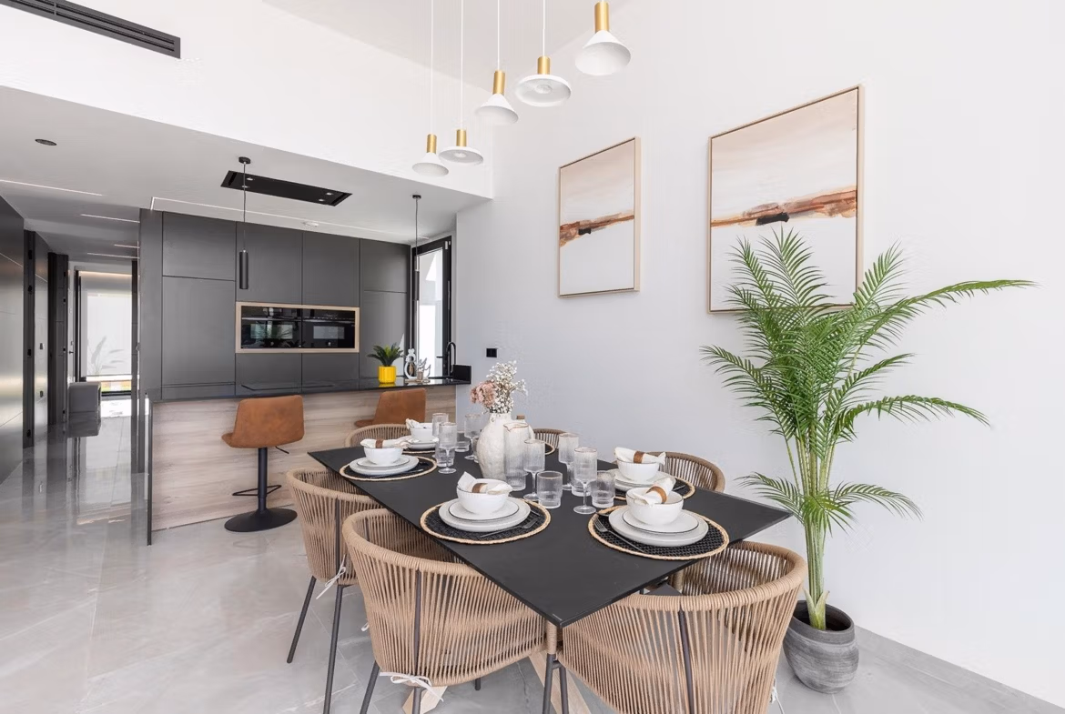 Bright open-plan dining area and sleek modern kitchen in key-ready single-storey villa, Los Balcones, Torrevieja.