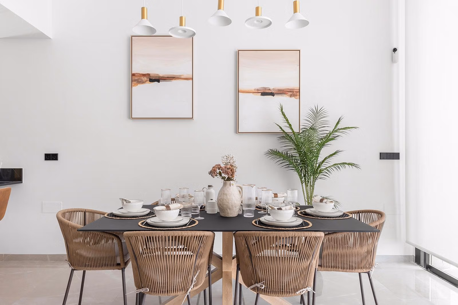 New-Build-One-Story-Villas-with-Private-Pool-in-Torrevieja-21 Elegant dining area with modern rattan chairs and minimalist art in a key-ready single-storey villa in Los Balcones, Torrevieja.