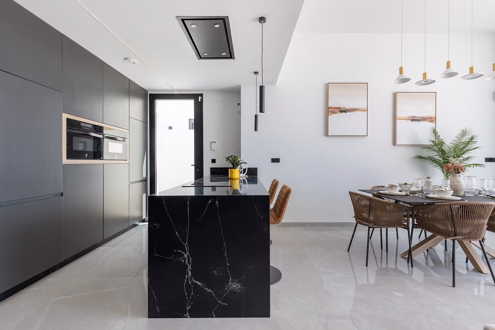 New-Build-One-Story-Villas-with-Private-Pool-in-Torrevieja-23 Modern open-plan kitchen and dining area with sleek black island and elegant finishes in a new build villa Los Balcones Torrevieja