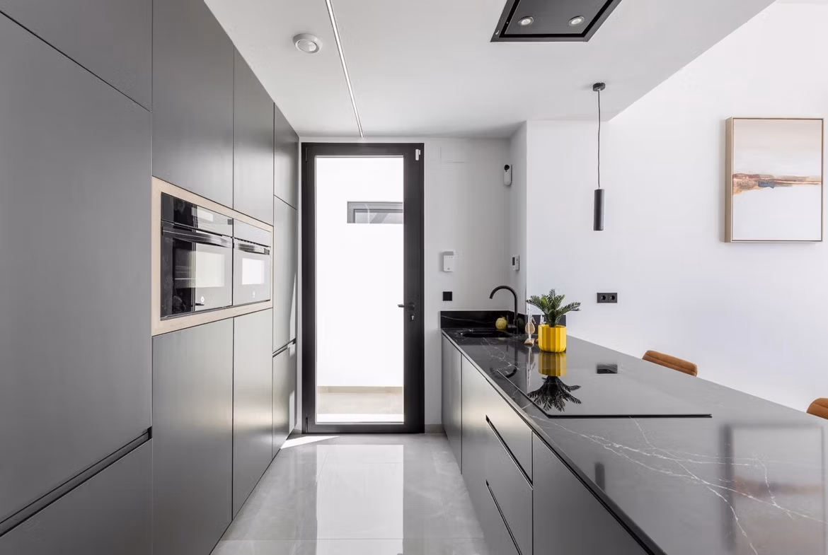 Modern sleek kitchen with matte grey cabinetry and black marble island in key-ready single-storey villa, Los Balcones, Torrevieja