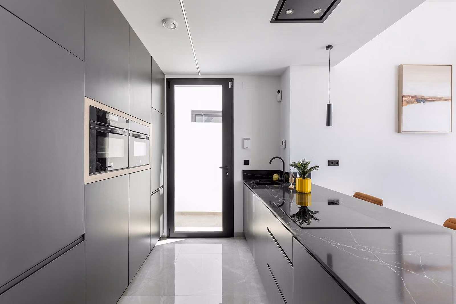 New-Build-One-Story-Villas-with-Private-Pool-in-Torrevieja-24 Modern sleek kitchen with matte grey cabinetry and black marble island in key-ready single-storey villa, Los Balcones, Torrevieja