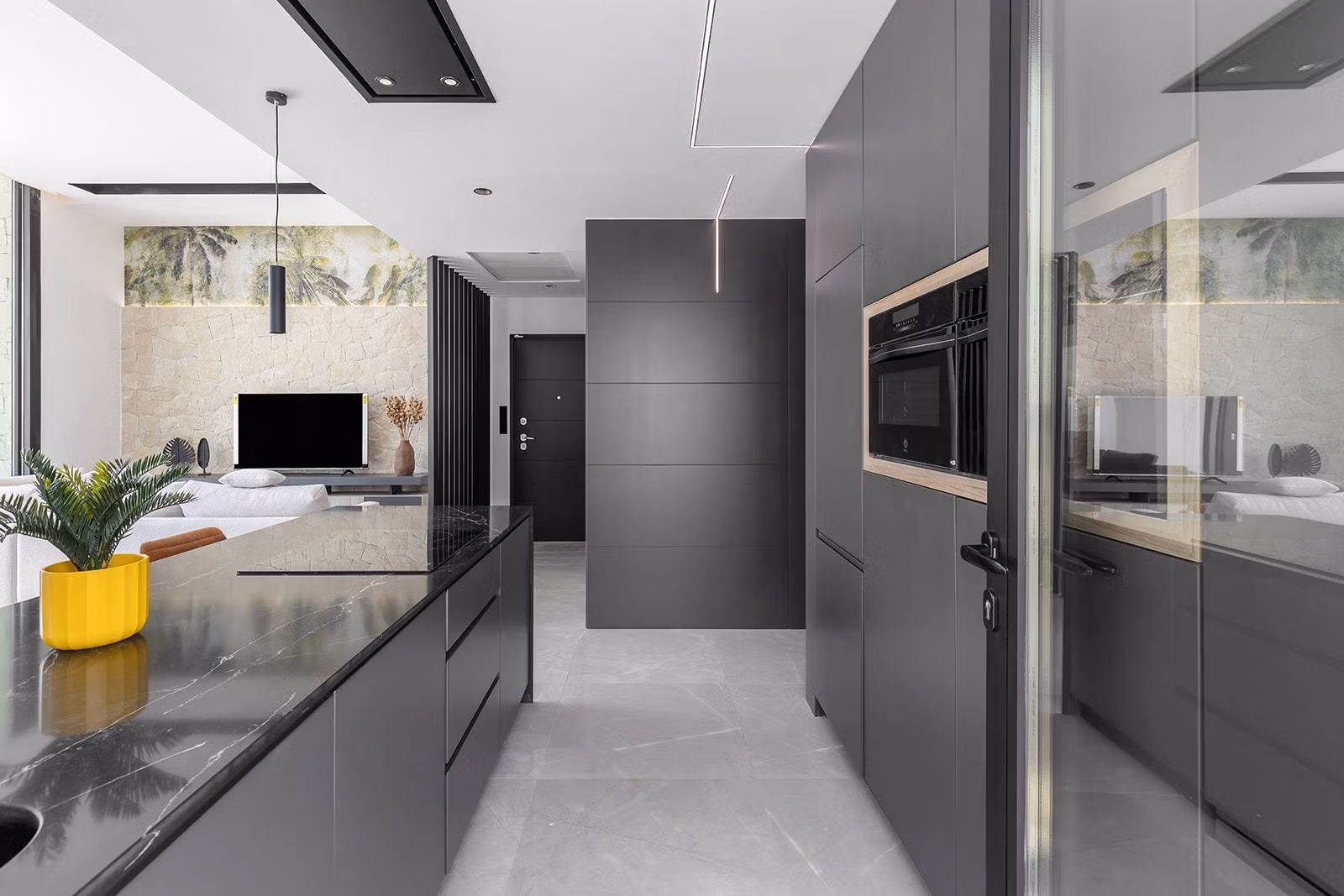 New-Build-One-Story-Villas-with-Private-Pool-in-Torrevieja-25 Sleek modern kitchen with dark cabinetry and elegant marble island in luxury single-storey villa, Los Balcones, Torrevieja.