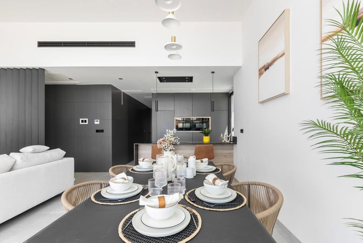 Bright open-plan dining and living area with modern kitchen in a luxury new build single-storey villa in Los Balcones, Torrevieja