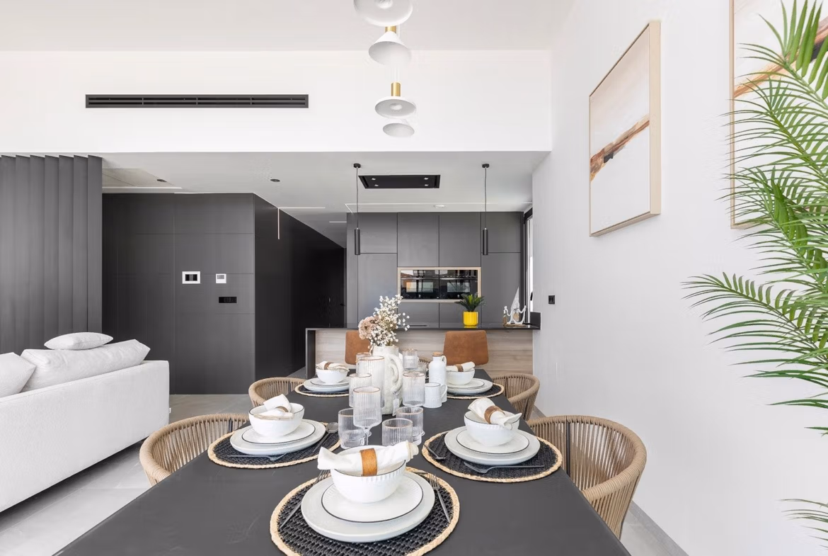 Bright open-plan dining and living area with modern kitchen in a luxury new build single-storey villa in Los Balcones, Torrevieja