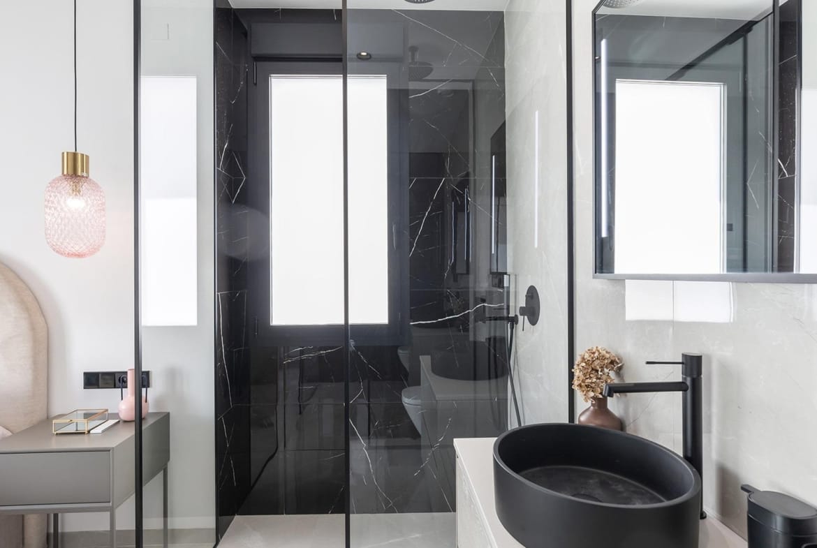 Modern elegant bathroom with black marble shower and sleek fixtures in key-ready single-storey villa in Los Balcones, Torrevieja