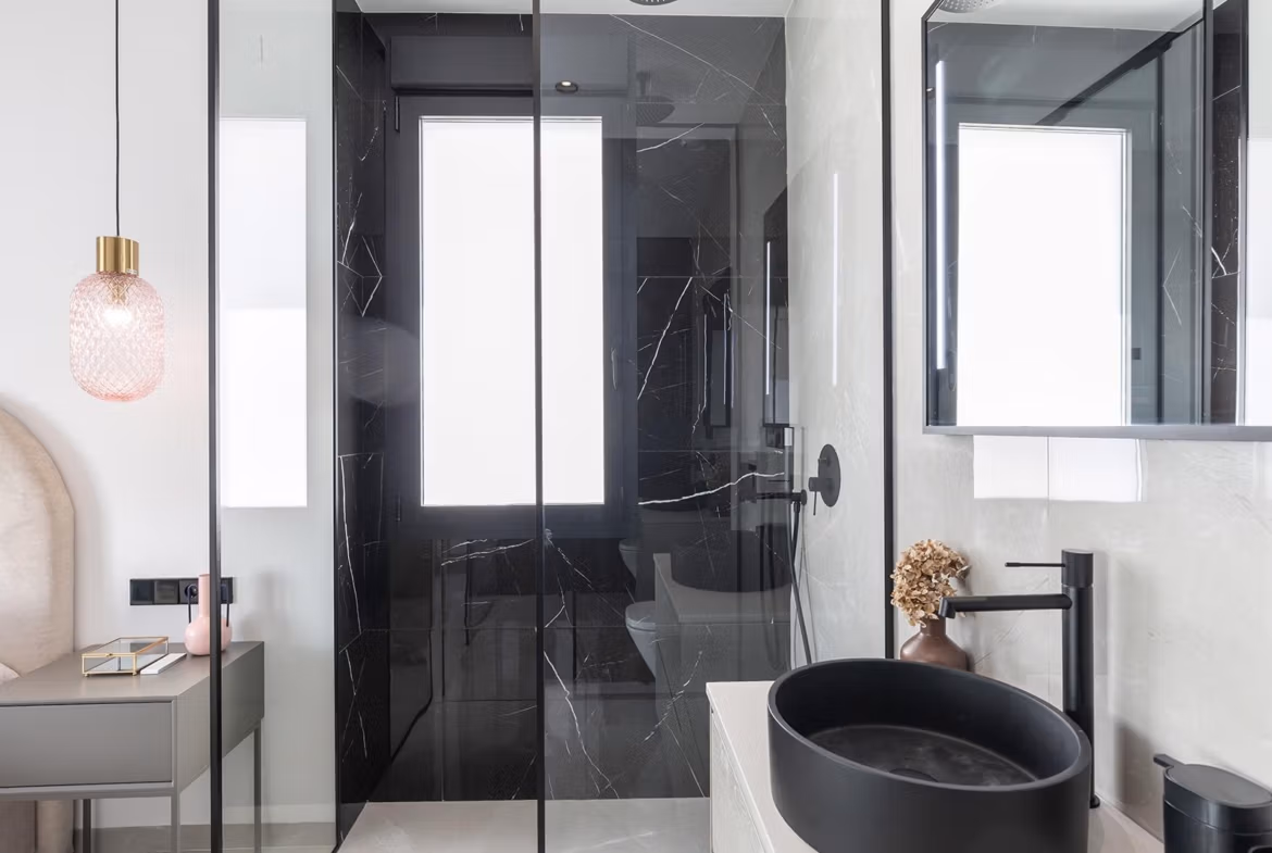 Modern elegant bathroom with black marble shower and sleek fixtures in key-ready single-storey villa in Los Balcones, Torrevieja