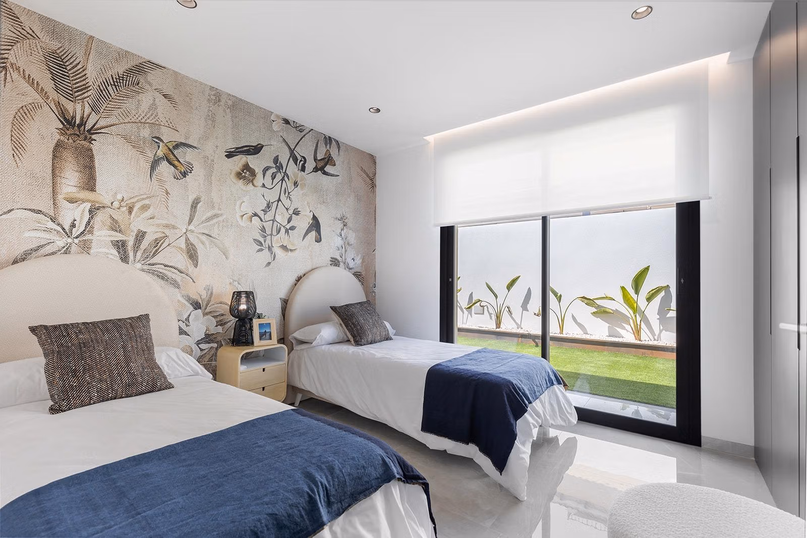 New-Build-One-Story-Villas-with-Private-Pool-in-Torrevieja-40 Bright, modern twin bedroom with elegant tropical mural and garden views in a key-ready single-storey villa, Los Balcones, Torrevieja.