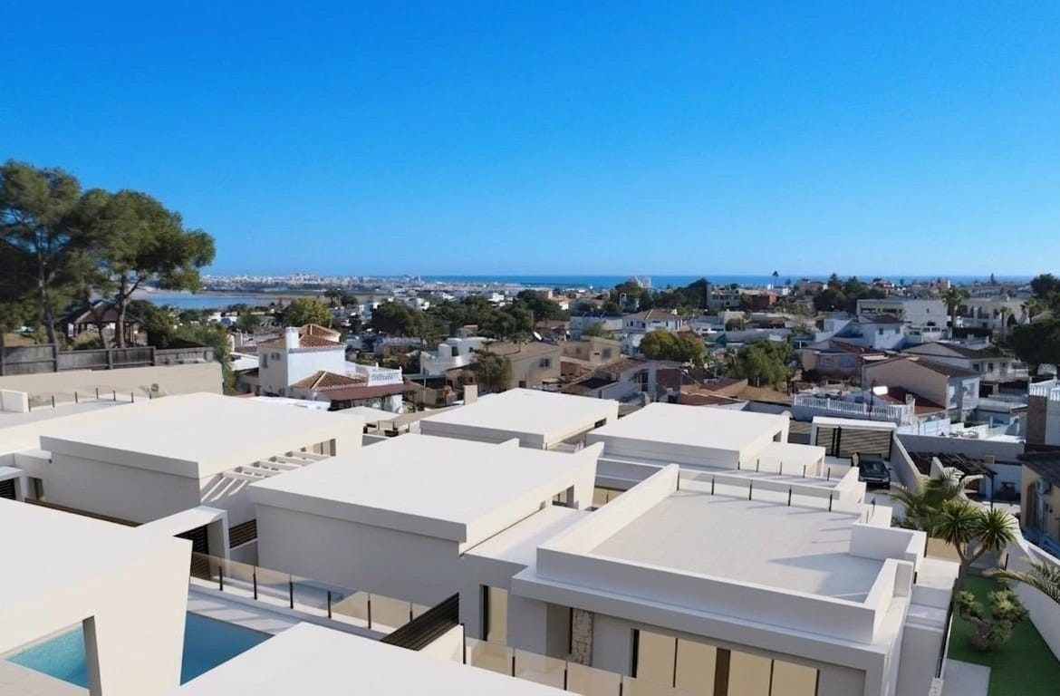 Modern single-storey villa with sleek white exterior and private pool overlooking the sunlit Los Balcones, Torrevieja neighborhood.