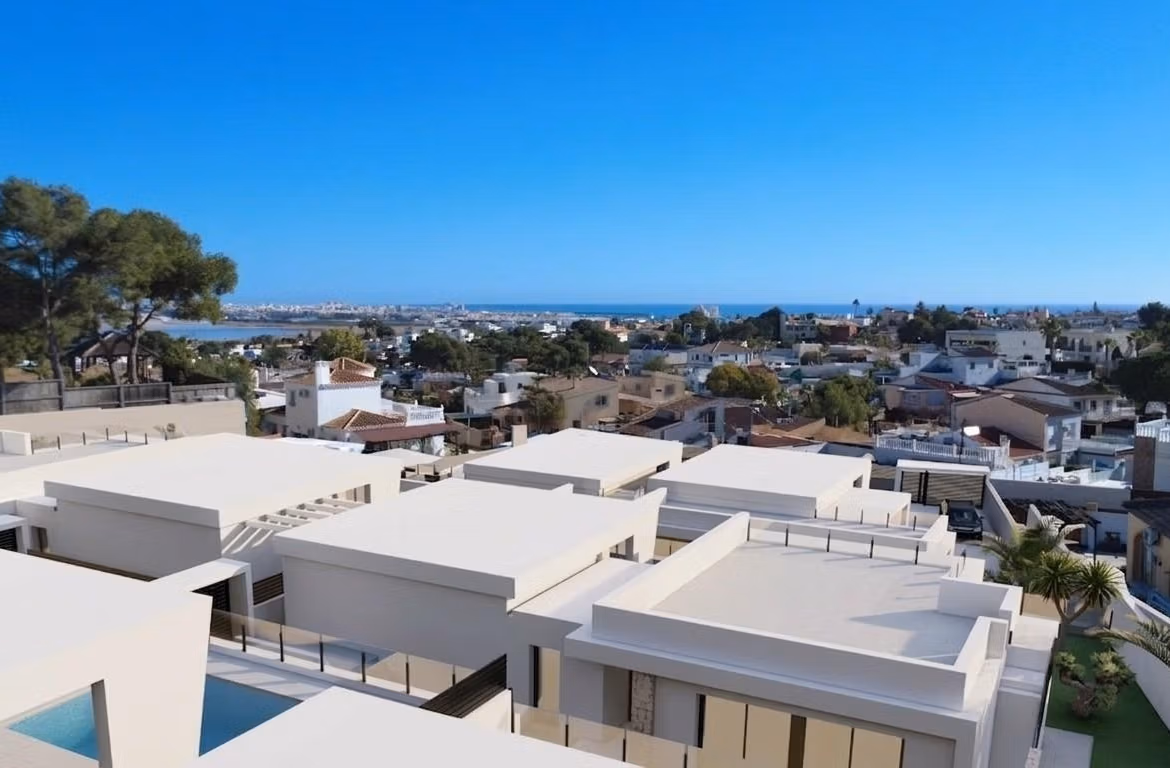 Modern single-storey villa with sleek white exterior and private pool overlooking the sunlit Los Balcones, Torrevieja neighborhood.