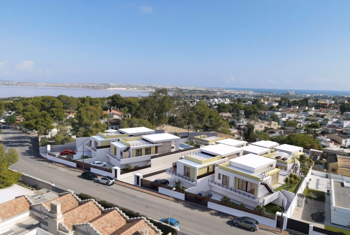 Modern single-storey villas with private pools and sleek terraces in sunlit Los Balcones, Torrevieja, overlooking lush surroundings.