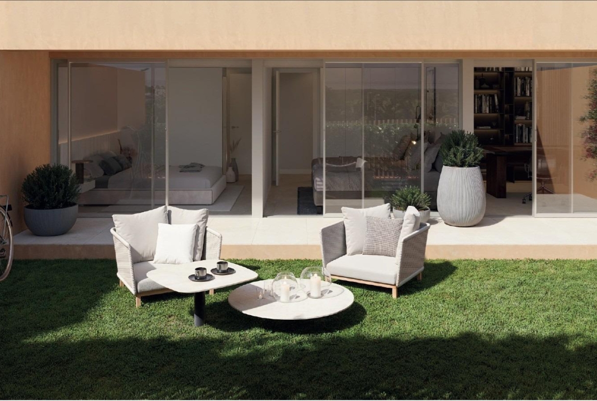 Modern sunlit terrace with comfortable seating and garden in new build residential apartments, Los Balcones, Torrevieja.