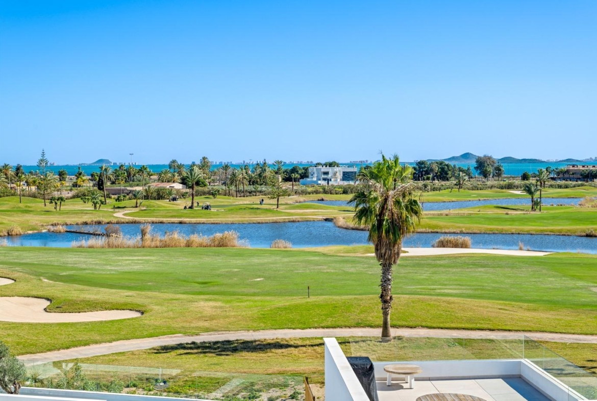 Panoramic golf course and water views from the private garden terrace of a modern 2-bedroom ground floor apartment in Serena Golf, Los Alcazares.