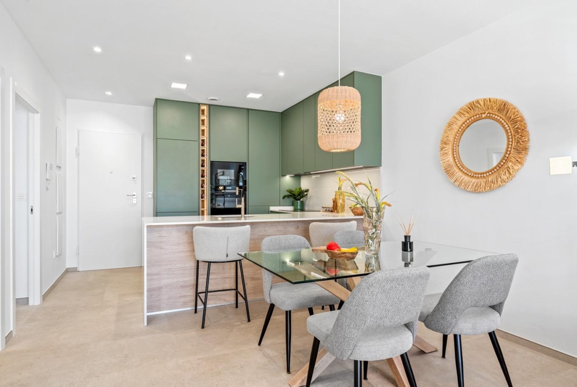 Bright modern open-plan kitchen and dining area in a 2-bedroom ground floor apartment with garden in Serena Golf, Los Alcazares.