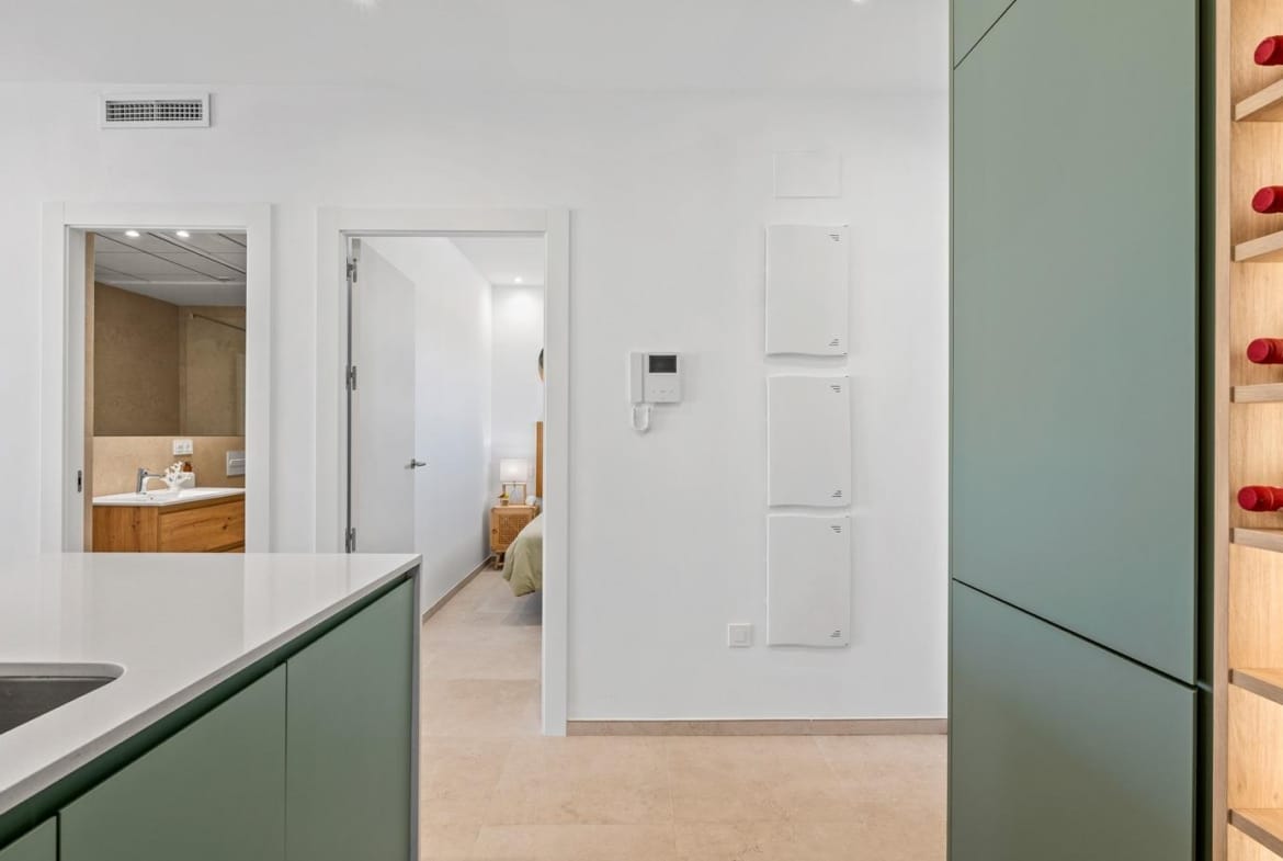 Bright modern kitchen and hallway with sleek cabinetry in a 2-bedroom ground floor apartment in Serena Golf, Los Alcazares